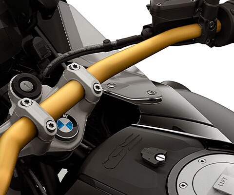 We see the golden handlebars with an integrated storage compartment.